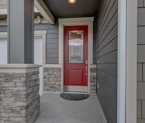Inviting entry with covered porch and upgraded front door.