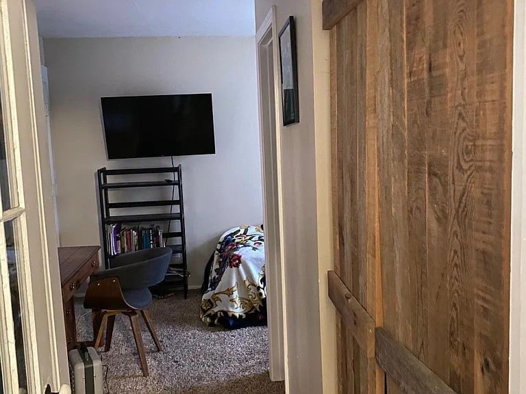 To 3rd bedroom from laundry/mud room 
Closet is on the right, another nook/closet space is behind the antique door