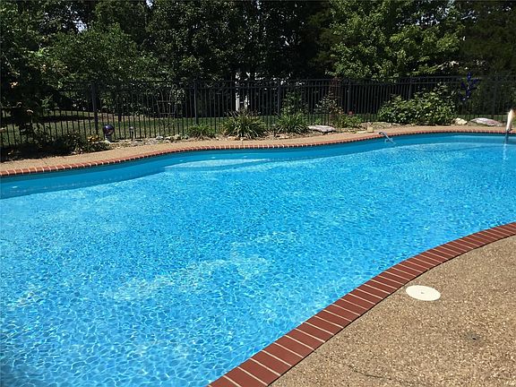 Beautiful tree-lined backyard, perfect for enjoying your summer days at the pool!
