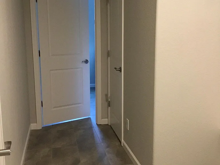 Left is garage door, straight ahead is laundry room, right door is powder room and bench with cubbies is closer to where photo was taken to the right.