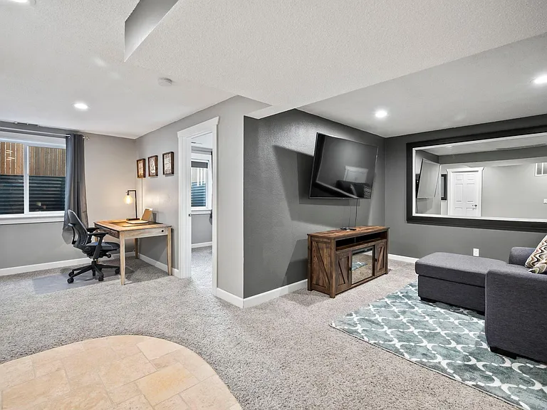 Enjoy the perfect blend of productivity and relaxation in your sunlit basement living room. The 67 inch Sony Smart TV allows for another great area to watch the game or your favorite shows.