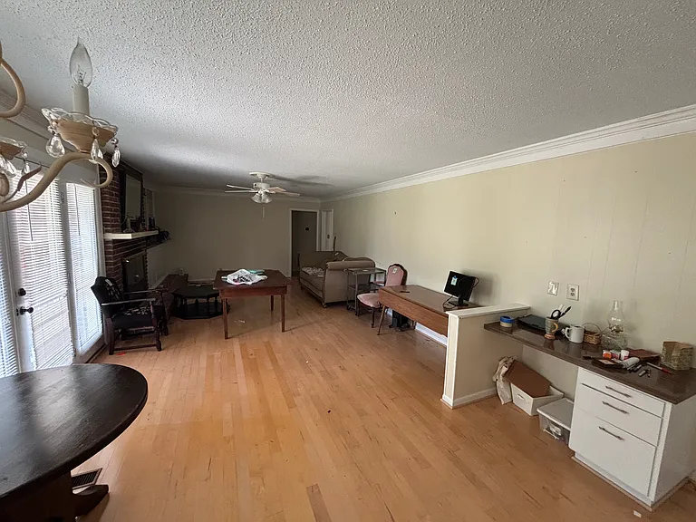 Large, well kept family room with breakfast table area, built-in desk, fireplace, overlooking back porch.