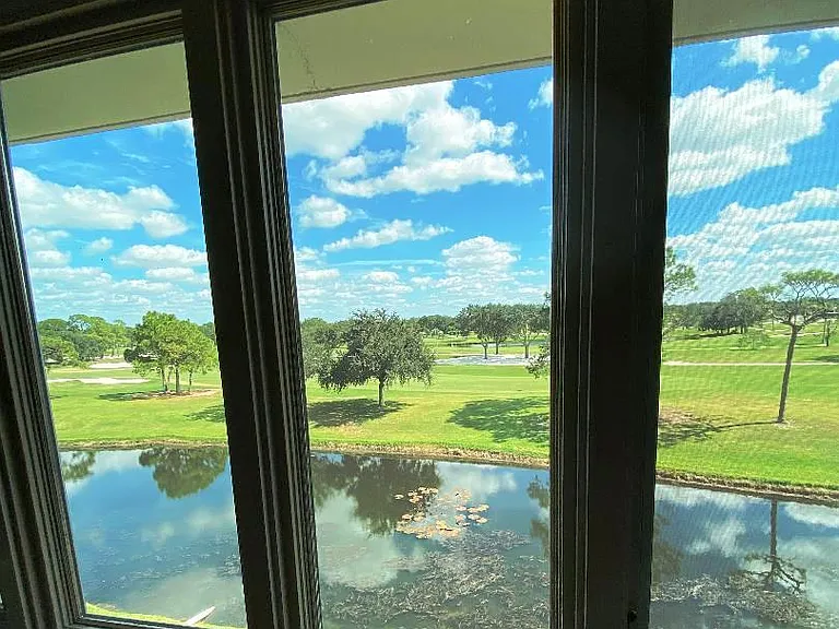 Custom Marvin Impact windows in den/guest bedroom provide clear view over golf course and beyond.