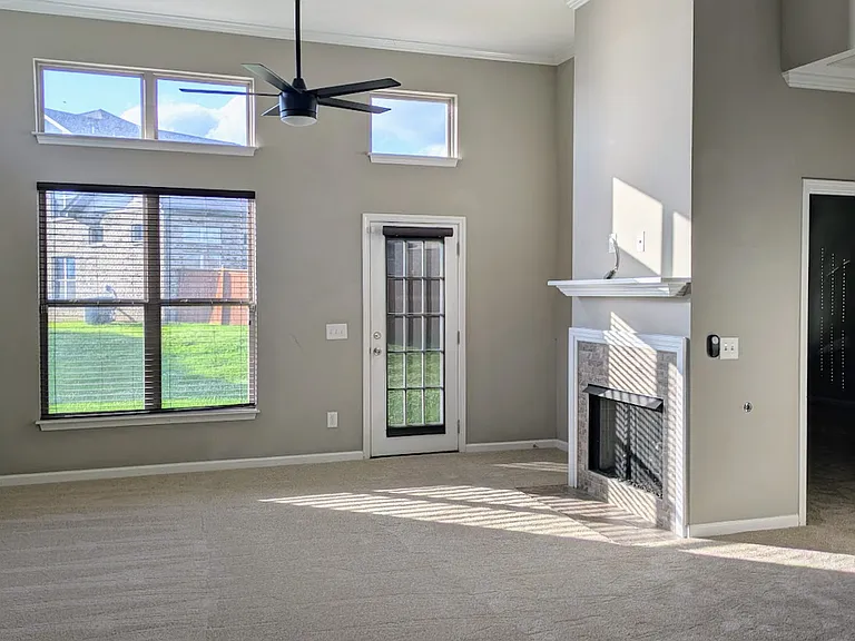 The living room has high ceilings, lots of natural light and a gas fireplace.