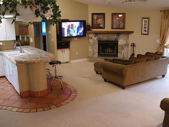 Living room. NOTE: carpet has been replaced with tile.