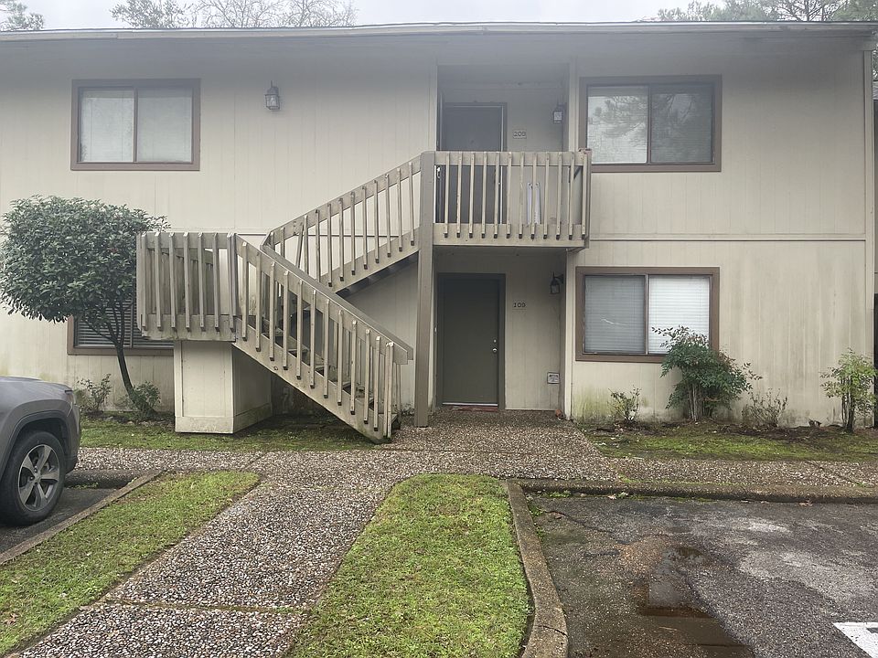 Unit 109, Building D with 1 assigned parking lot space and guest parking available.