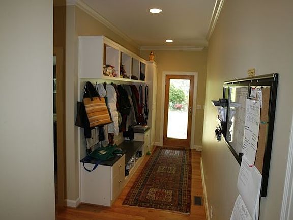 mudroom w/ custom cabinetry and front & rear door access