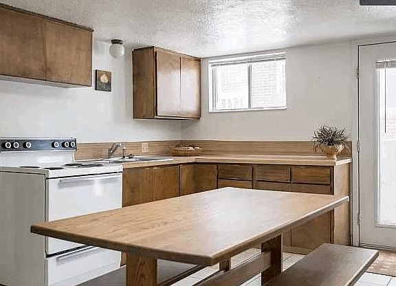 Kitchen has wood cabinets, lots of counter space and plenty of room for a full-size table.