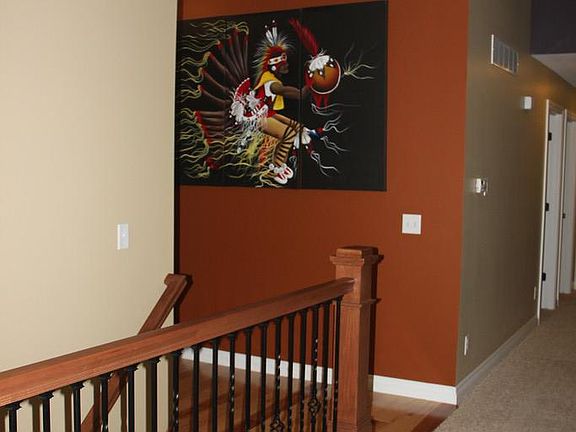 A wrought iron balustrade keeps the living room sight lines open.