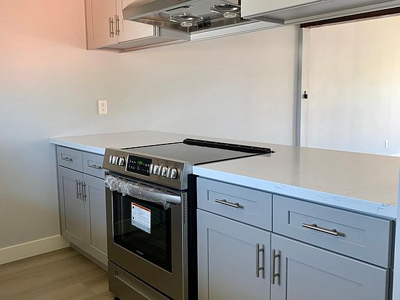 New kitchen with new solid maple cabinets, granite countertop, oven range and upgraded stove hood