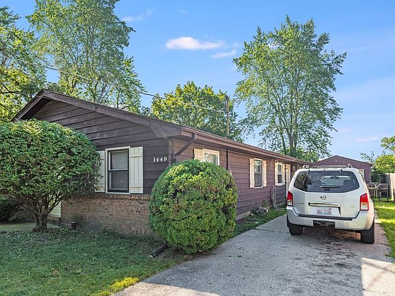 Exterior 1449 Side with long Driveway and Garage.