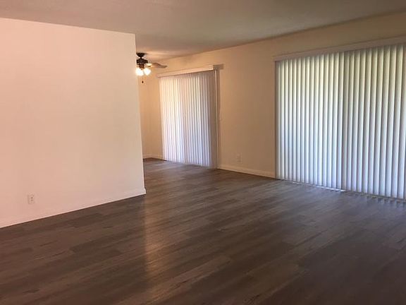 Large living room showing new window treatments throughout.
