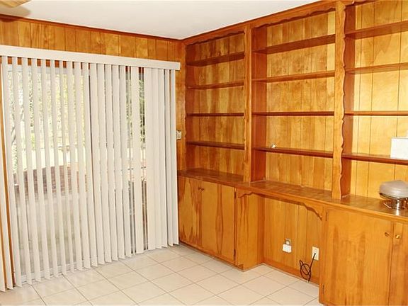The family room also has tile flooring, ceiling fan, fireplace and awesome built-ins.