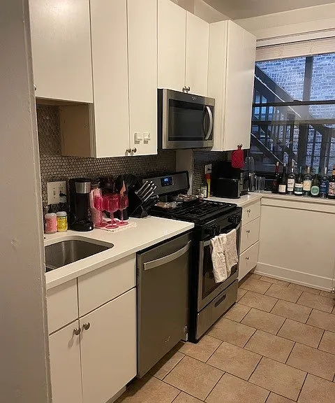 RENOVATED KITCHEN WITH STAINLESS STEEL APPLIANCES