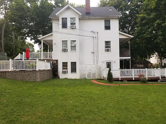 Door entrance to 1st floor apartment with large deck. Also storage shed under deck above and parking for this apartment close to entrance