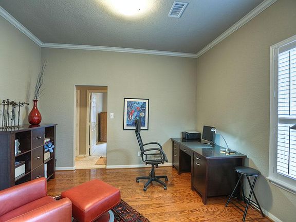 Opposite the dining room is a study with wood floors and French doors. Also, a door to the front hallway.