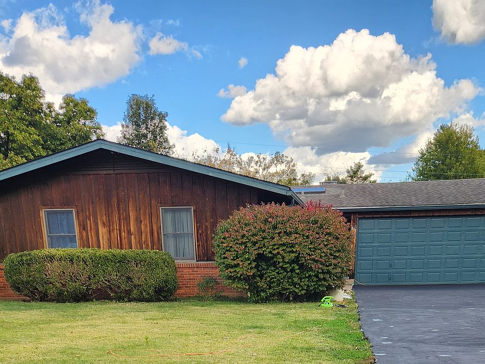 Street view of house, apartment entrance is to right of garage. It is a seperate unit attached behind garage.