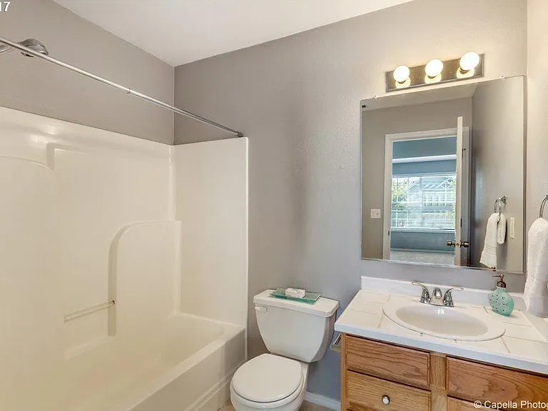 On suite bathroom with bath tub and vanity.