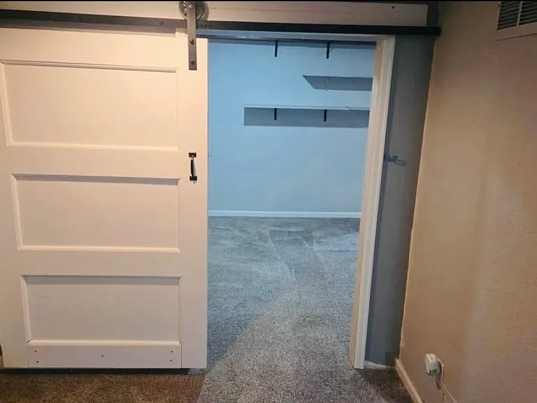 Barn door leading into the second bedroom