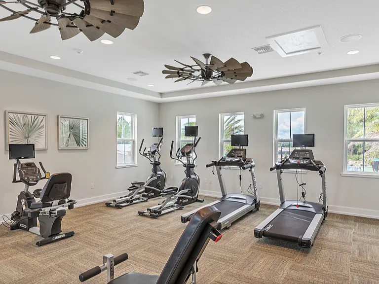 Well-equipped Fitness Center w/ large screen TVs