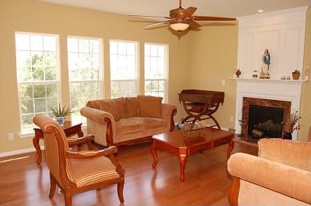 Living room has hardwood floors and fireplace