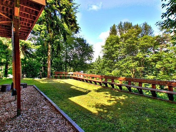 Large lot backs to greenbelt for ultimate privacy. This home lives like a tree house. Notice the swing hanging beneath the deck.