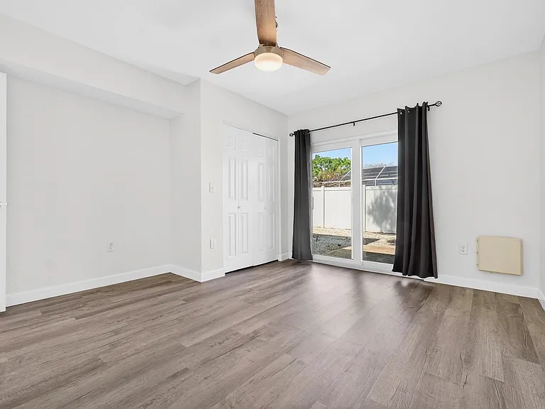 Bedroom with ceiling fan, full size closet and blackout curtains