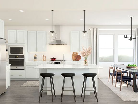Kitchen with white cabinets pendant lights