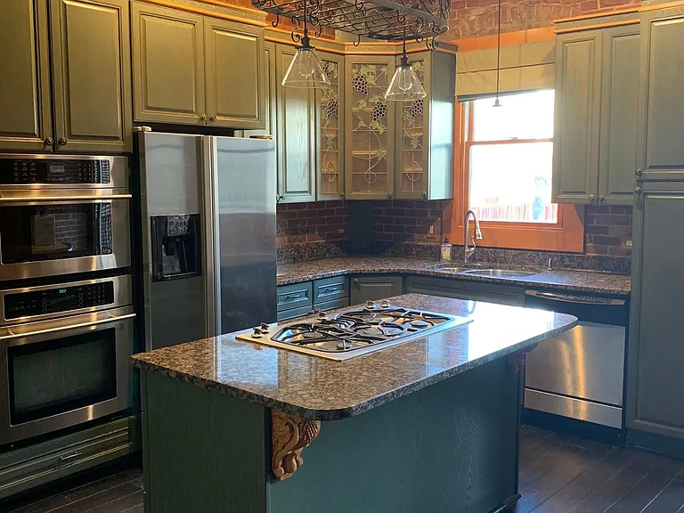 Kitchen. Gas range on island. Room or 2-3 bar stools. Gas oven and built-in microwave. Stainless fridge/freezer and dishwasher.