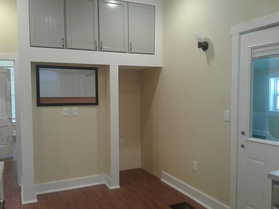 Kitchen, black fridge to be installed soon, door access to mud rm / laundry rm