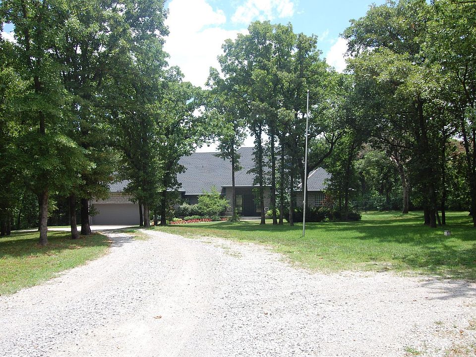 WInding tree lined road leads to this custom Contemporary home on 5 acres.
