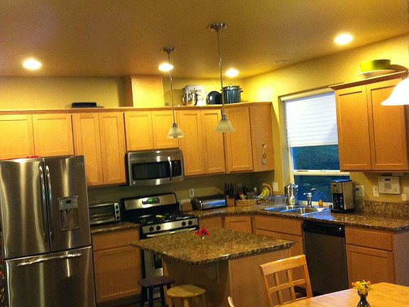 kitchen with stainless appliances, slate floor, and granite countertops