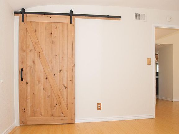 Barn door leads to masterbath