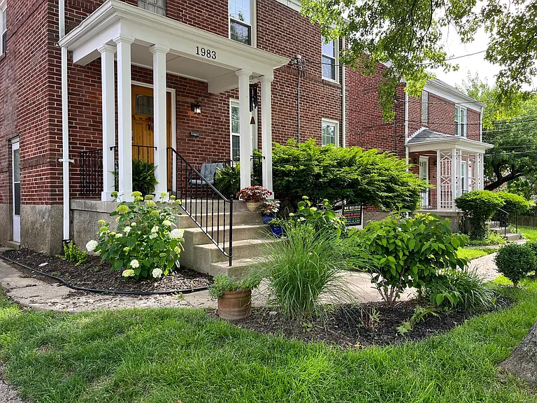 Front of duplex brick house with steps.