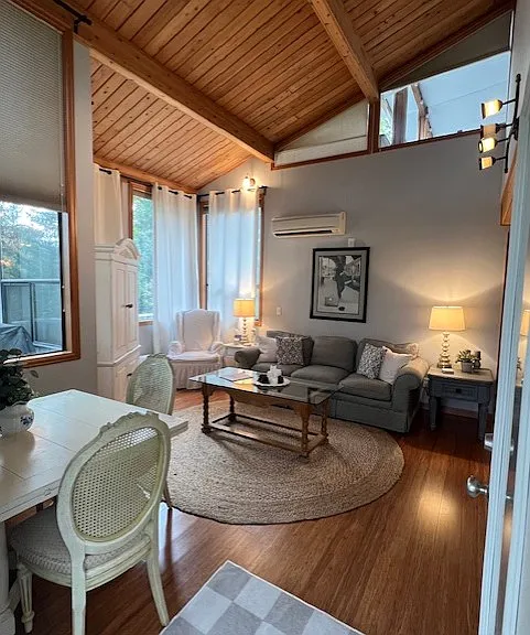 Welcome to your new cozy space! This view of the main living and dining space greets you as you enter through the front door of your private entrance. Naturally bright with super-high cathedral ceilings and tall windows.