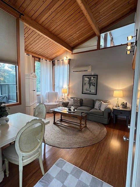 Welcome to your new cozy space! This view of the main living and dining space greets you as you enter through the front door of your private entrance. Naturally bright with super-high cathedral ceilings and tall windows.
