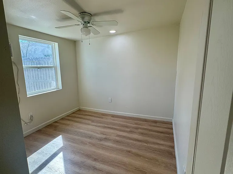New window, ceiling fan, and wall AC/Heater unit.