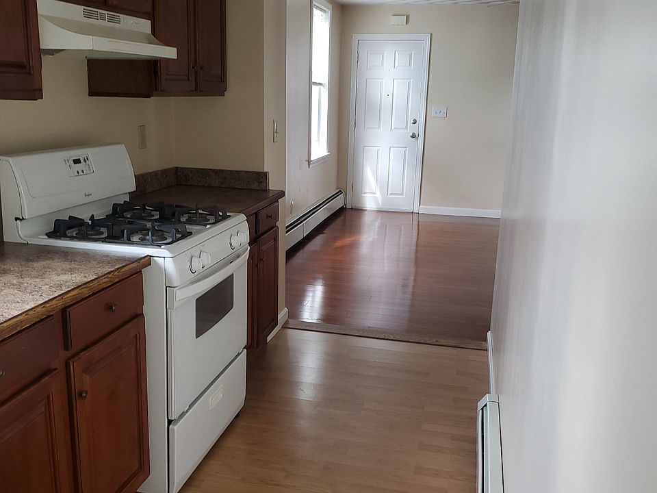 Kitchen looking out to dining room and apartment entrance