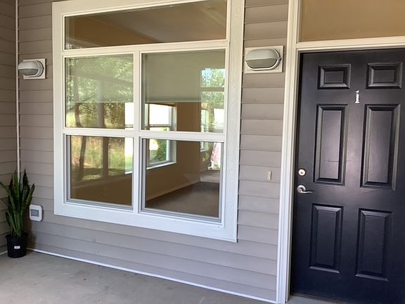 Front door in enclosed porch area.