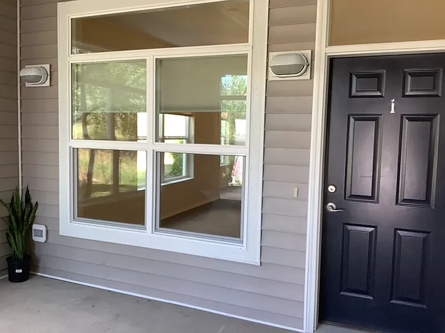 Front door in enclosed porch area.
