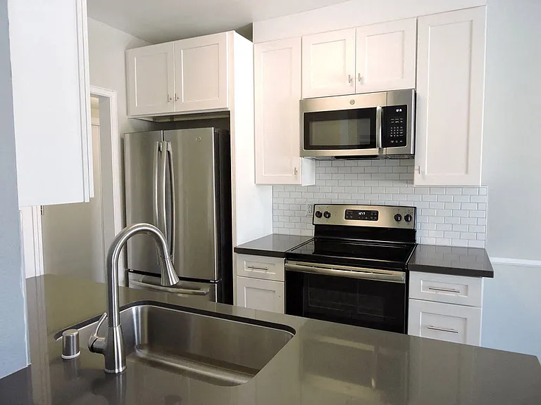 Newly renovated kitchen with white subway tile back-splash