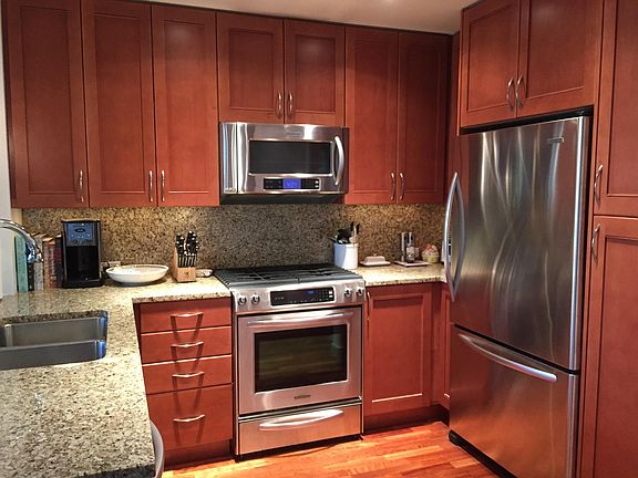 Chefs kitchen with gas cooktop and stainless steel appliances