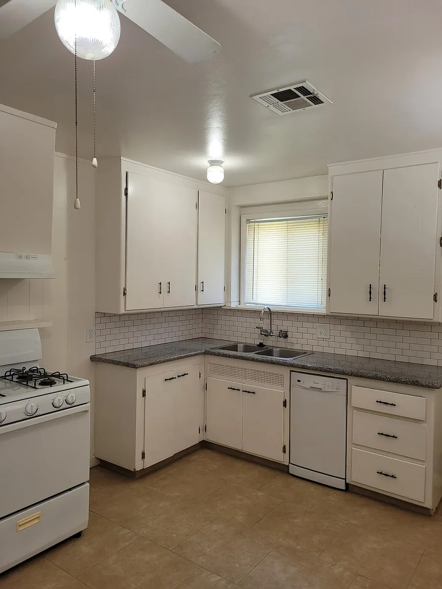 Kitchen with granite countertops and gas stove. - 220 W Feemster Ave
