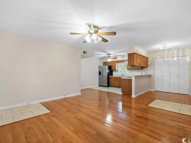 Living Room with view of Kitchen and Laundry Area