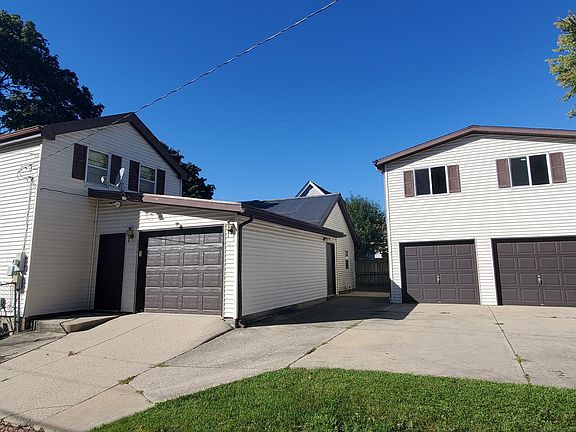 Outside with 2 story garage.