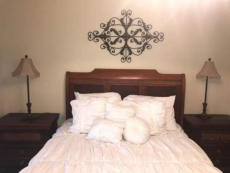 2nd bedroom with queen bed set with two night stands, dresser and large closet