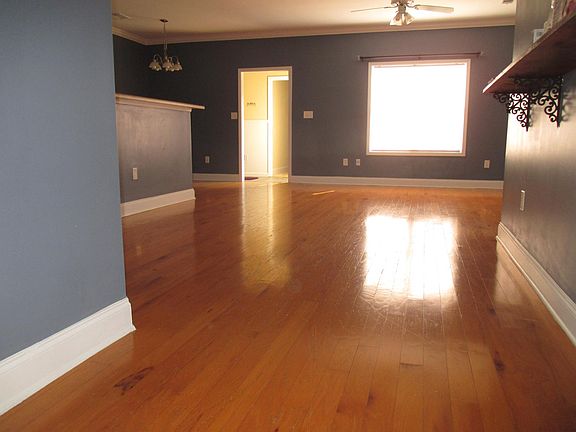 Living room with kitchen and breakfast nook on left. Master bedroom and half bath through doorway.