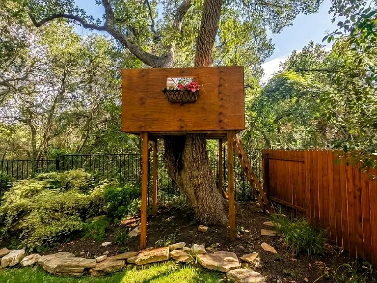 Treehouse tucked into a mature live oak _ a backyard favorite