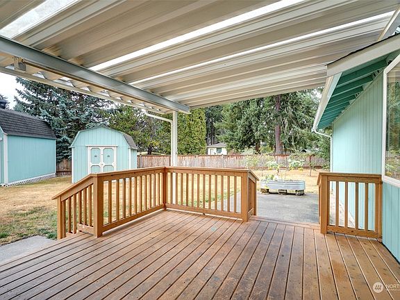 Covered deck to enjoy in all seasons... Nice patio as well.>