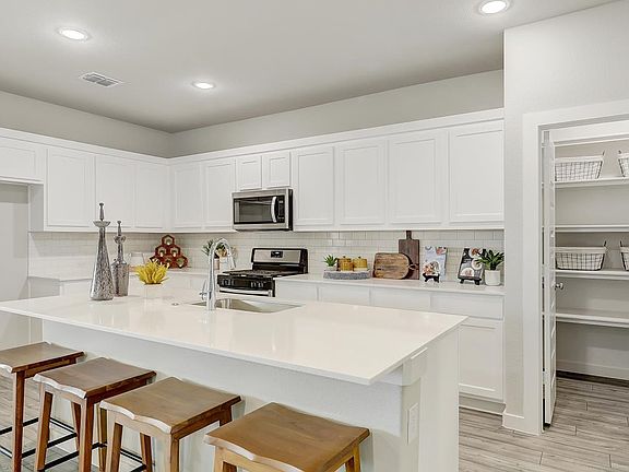 Kitchen in the Oscar home plan by Trophy Signature Homes - REPRESENTATIVE PHOTO